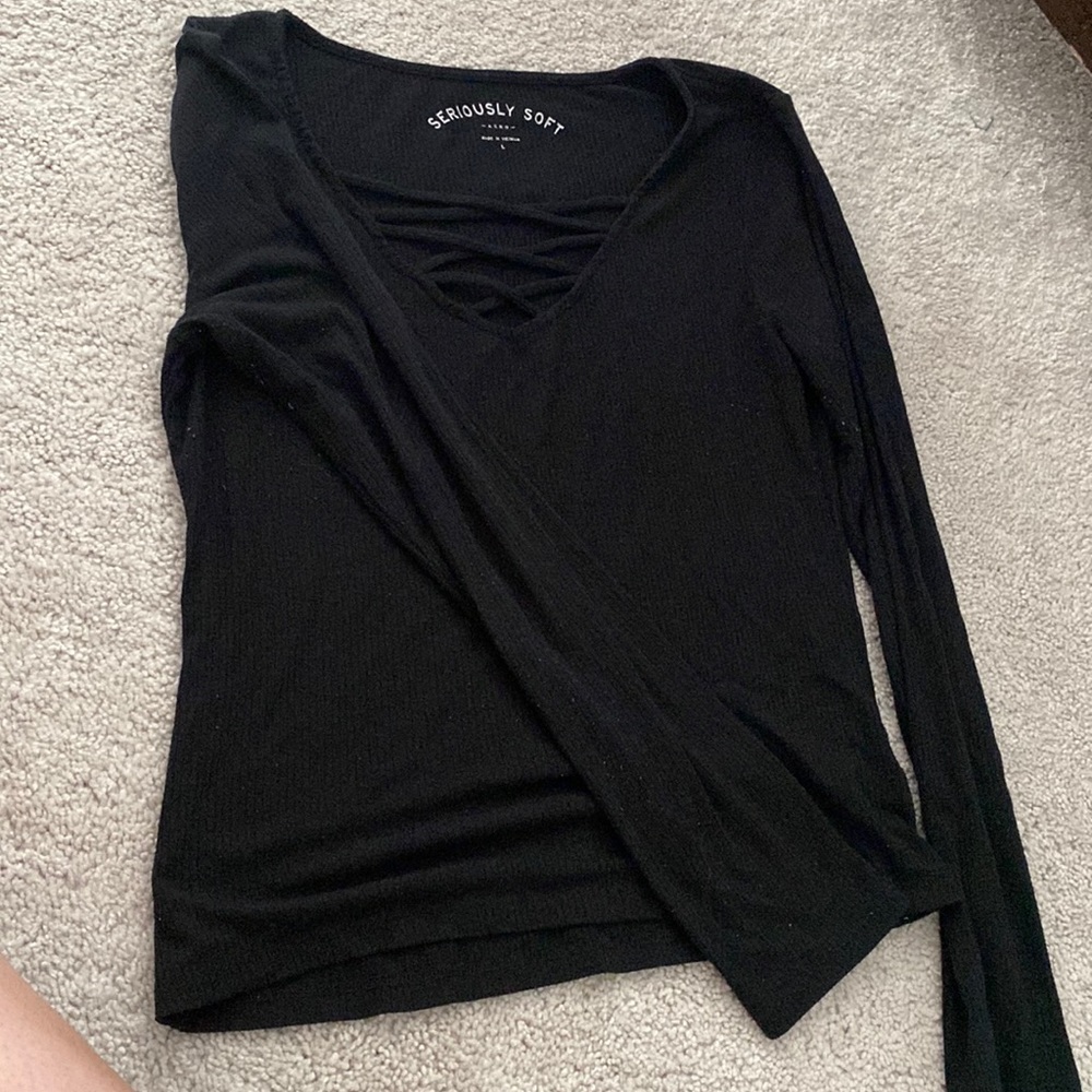 Black, stretch long sleeve with crisscrossed v-neckline.